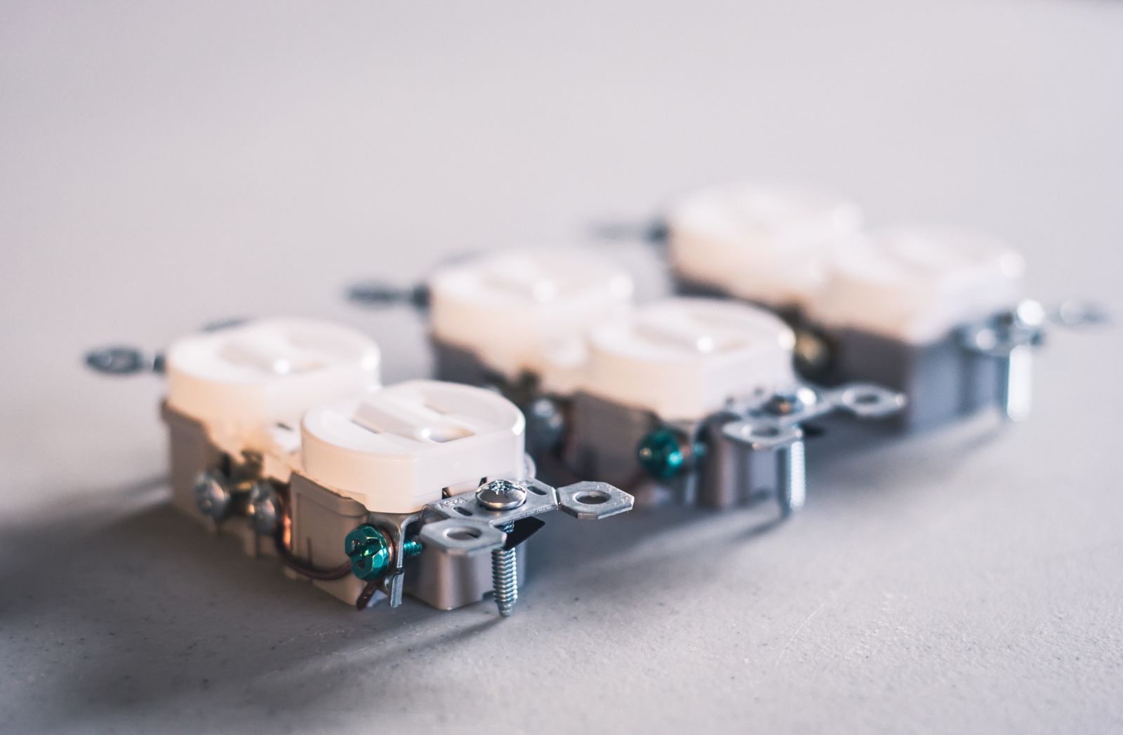 Three white wall sockets installed on a wall